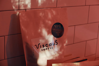 Sonar Wave coffee bag in dappled light against terracotta tiles